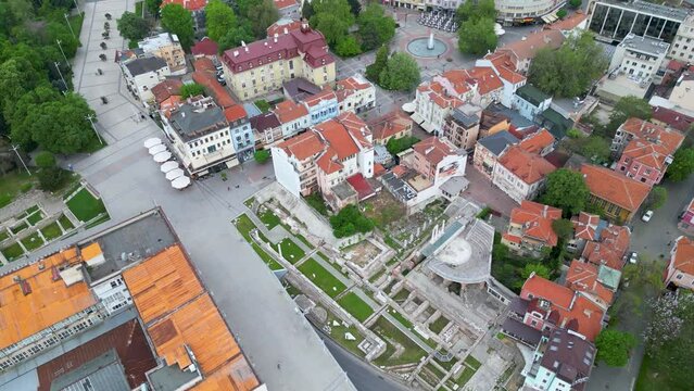 Aerial drone shot of Plovdiv city center. Ancient city in Bulgaria seen from above during a cloudy morning. Flyover footage of the Touristing city of Philippopolis in Thracia. Old Town. Tepe visible
