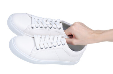 White leather sneakers in hand on white background isolation