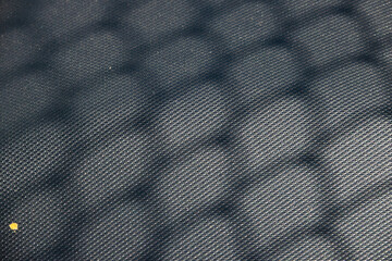 A close up of a blue fabric with a pattern of circles. The circles are of varying sizes and are...
