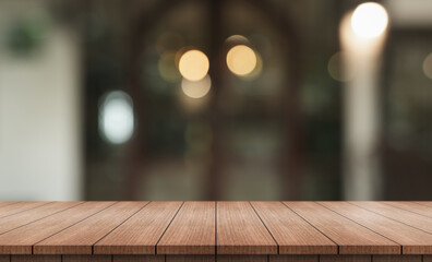 Empty wooden table top with lights bokeh on blur restaurant background.
