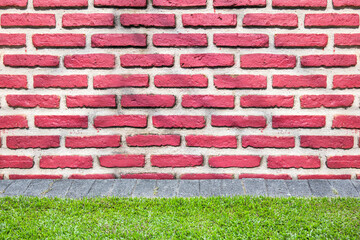 Background of old brick wall texture with grass ground.