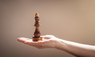 game of chess. Chess pieces in a woman's hand.