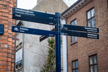 Copenhagen, Denmark - April 6, 2024: Directional signpost, arrows pointing to main sights in Copenhagen city center. Tourist guide information post. Travelling in Denmark.