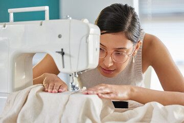 Tailor, sewing machine and woman in apartment for small business, fashion design and working....