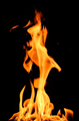 fire on a black background, burning and hot flames, close view