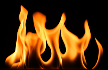 fire on a black background, burning and hot flames, close view