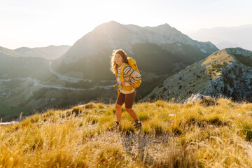 Portrait of a tourist on the mountain and enjoying freedom. Adventures. Active life. Lifestyle,...