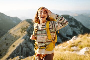 Portrait of a tourist on the mountain and enjoying freedom. Adventures. Active life. Lifestyle,...