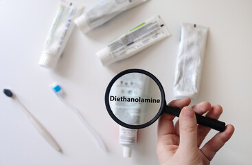 Dangerous toothpaste ingredient diethanolamine. Checking the composition of toothpaste with a...