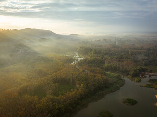 Aerial view canal river through tropical rainforest mountain morning sunrise nature landscape