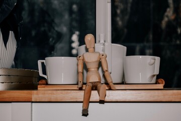 Photo Of A Wooden Figurine Sitting