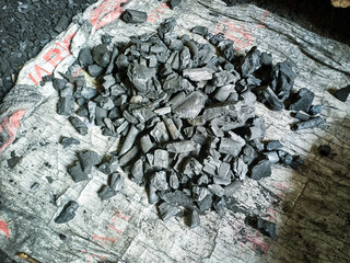 Black gray charcoal materials photographed during the daytime. Used charcoal in the garden of the village house.used for ironing.