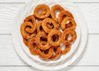 deep fried crispy onion rings on white plate