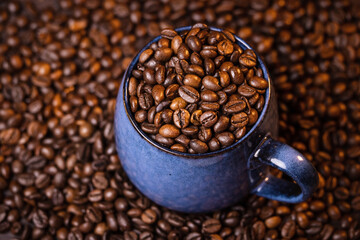 many macro aromatic coffee beans in a cup