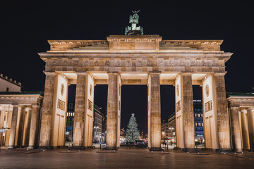 Illuminated Brandenburg Gate and Christmas Tree in Berlin at Night with Festive Lights