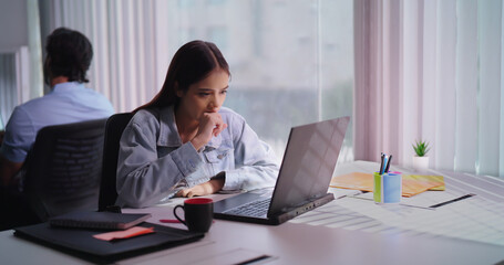 Indian young adult gen z busy woman lady sitting use tablet look screen do work check email data indoor job office place teen female girl read online day task search new project plan ideas on touchpad