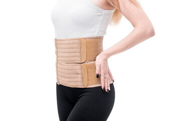 woman wearing lumbar support belts. pregnant and postnatal lumbar brace after surgery isolated on...