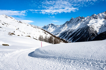 Ski run in winter resort with mountains in background, Loetschental valley, Switzerland