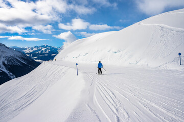Unidentified man skiing on groomed slope during winter season, Loetschental valley, Switzerland