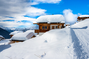 Winter snowy road with typical wooden houses in alpine village, Loetschental valley, Switzerland