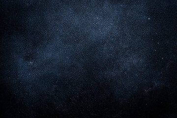 Black painted concrete texture or background with shadow and grain elements. High contrast and...