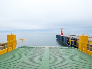Ferry dock in a harbour and navigation sign on a pier 