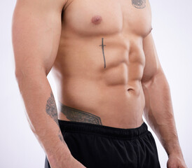 Muscle, man and body abdomen with tattoo for health, wellness or fitness in studio isolated on...