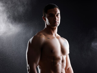 Man, portrait and fitness abs in studio for wellness or body builder, strong and dark for power or strength. Person, six pack and smoke with muscle, isolated and black background for aesthetic shadow