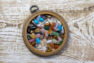 Collection Of Semi-Precious Gemstones on white wood textured background