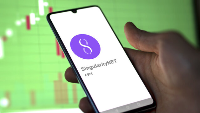 Close up on logo of (AGIX) SingularityNET on the screen of an exchange. (AGIX) SingularityNET price stocks, $AGIX on a device.