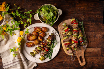 Lamb skewers with potato and salad