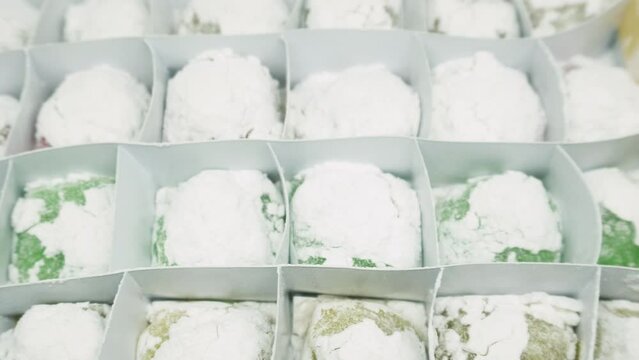 Mochi variants of various colors and flavors such as Pandan, Chocolate, Moca, Milk, Cheese. Mochi is made from sticky rice which is finely ground and then shaped into rounds and flavored