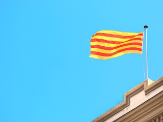 The Catalan flag, or senyera, waving in the sky, is the symbol of the Autonomous Community of Catalonia