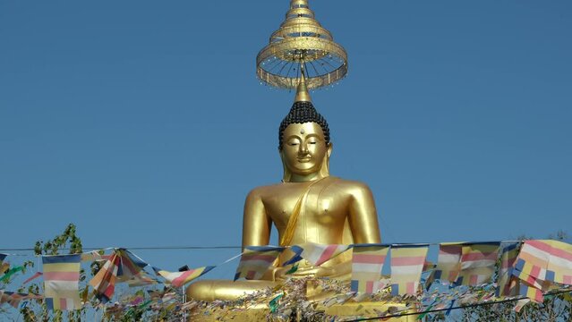 golden buddha statue and flags, Pattaya, Thailand