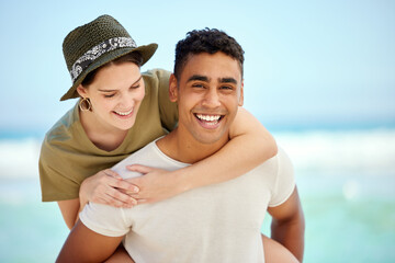 Portrait, smile and couple piggyback at beach on holiday, travel or summer vacation together. Face,...
