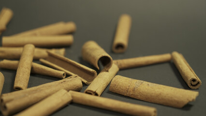 Cinnamon sticks isolated on dark background. Cinnamon packaging