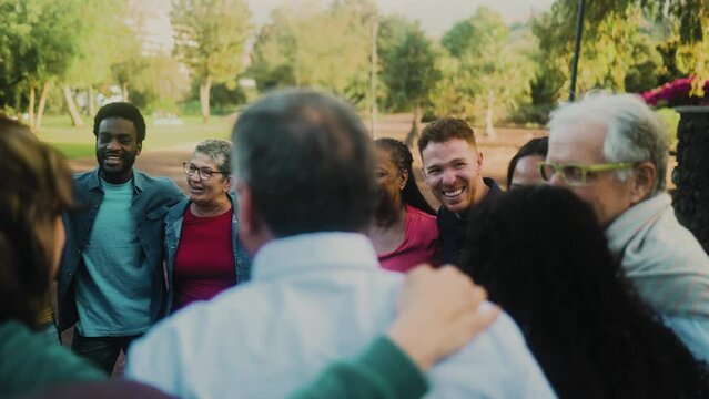 Happy multigenerational group of people with different ethnicities having fun in a public park - People diversity concept