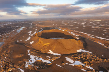 Cosmic mystical drone inspects snow-capped mountains and pseudo-craters. Myvatn in north of Iceland.