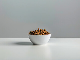 A bowl of chocolate on a white table. - obrazy, fototapety, plakaty