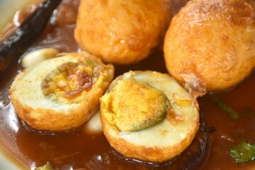 fried egg half cut dressing sweet tamarind sauce topping chili on plate