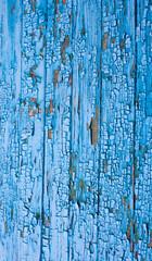 Wooden surface with cracked blue paint
