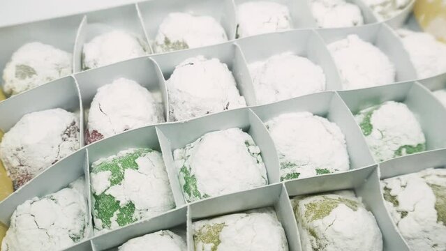 Mochi variants of various colors and flavors such as Pandan, Chocolate, Moca, Milk, Cheese. Mochi is made from sticky rice which is finely ground and then shaped into rounds and flavored