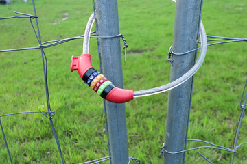 Padlock combination lock with chain on the fence