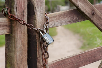 Padlock combination lock with chain on the fence.