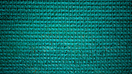 Plastic mesh background with knitted lines and irregular texture with a dark green gradient. For backdrops, decorations, frames