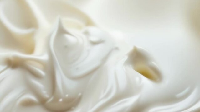 Smooth and creamy whipped cream swirls in an enticing dance, forming soft peaks that invite a sense of indulgence. The luxurious texture ebbs and flows in a soothing rhythm, perfect skin