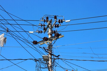 Power electric pole with line wire on colored background close up. Photography consisting of power...