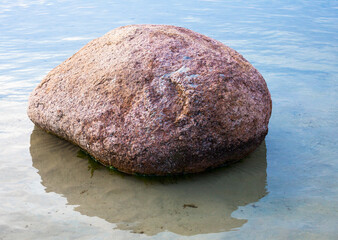 Big stone in shallow water.
