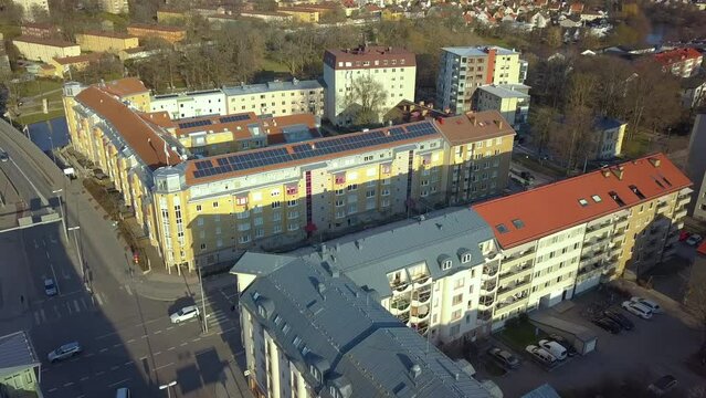 Renewable electricity development. Solar photovoltaic panels mounted on roof of Swedish condo building in Linkoping residential area