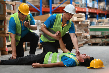 Two workers are helping and ask for help on a walkie-talkie while his co-worker is lying...